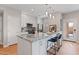 Modern kitchen featuring a granite island, stainless steel appliances, and white cabinetry at 11500 E Cochise Dr # 1094, Scottsdale, AZ 85259