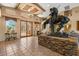 Grand lobby featuring a statue on a stone plinth, tiled floor and view to a courtyard with glass entry doors at 11500 E Cochise Dr # 1094, Scottsdale, AZ 85259