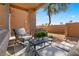 Cozy patio area with comfortable chairs, a small table, and landscaping creating a tranquil outdoor space at 11500 E Cochise Dr # 1094, Scottsdale, AZ 85259
