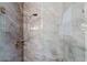 Walk-in shower with gray stone tile, adjustable shower head and glass enclosure at 11500 E Cochise Dr # 1094, Scottsdale, AZ 85259
