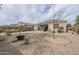 Spacious backyard with low-maintenance desert landscaping, covered patio, and fire pit area at 1189 E Tyler Ln, Casa Grande, AZ 85122