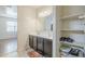 Bathroom with double sinks and adjacent shelving for storage at 1189 E Tyler Ln, Casa Grande, AZ 85122