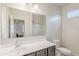 Bright bathroom with a large mirror, sink, and toilet, providing a functional and clean space at 1189 E Tyler Ln, Casa Grande, AZ 85122