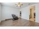 A bright bedroom with wood-look flooring, ceiling fan and view into other rooms at 1189 E Tyler Ln, Casa Grande, AZ 85122