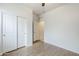 A bedroom with wood-look flooring, closet with sliding doors, and a doorway leading to the hall at 1189 E Tyler Ln, Casa Grande, AZ 85122