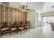 Elegant dining room with decorative wood accent wall, a ceiling fan and seating for six at 1189 E Tyler Ln, Casa Grande, AZ 85122