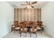 Formal dining room with wood accent wall, ceiling fan, and a large wooden table with seating for eight at 1189 E Tyler Ln, Casa Grande, AZ 85122