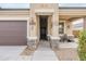 Inviting front entryway with stone pillars, decorative wall art, and a covered porch at 1189 E Tyler Ln, Casa Grande, AZ 85122