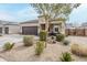 Lovely home with a spacious driveway, desert landscaping, and a welcoming entrance at 1189 E Tyler Ln, Casa Grande, AZ 85122