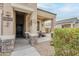 Cozy front porch with stone accents, decorative wall art, and space for seating at 1189 E Tyler Ln, Casa Grande, AZ 85122