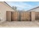View of the tall wooden privacy gate and desert landscaping at 1189 E Tyler Ln, Casa Grande, AZ 85122