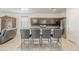Open kitchen with stainless steel appliances, a large island with bar seating, and tile flooring at 1189 E Tyler Ln, Casa Grande, AZ 85122