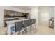 Modern kitchen with stainless steel appliances and a granite-topped island with seating for four at 1189 E Tyler Ln, Casa Grande, AZ 85122