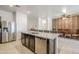 Kitchen island with granite countertop, stainless steel dishwasher and a view of the dining area at 1189 E Tyler Ln, Casa Grande, AZ 85122