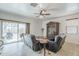 A spacious living room featuring tile flooring, a ceiling fan, sliding glass doors, and comfortable seating at 1189 E Tyler Ln, Casa Grande, AZ 85122