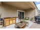 Cozy outdoor kitchen with seating and a built-in sink and refrigerator at 1189 E Tyler Ln, Casa Grande, AZ 85122