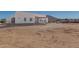 Wide view of a modern home showcasing the backyard and desert landscape at 14902 W Oberlin Way, Surprise, AZ 85387
