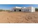 Modern home featuring a covered patio and spacious backyard with desert landscape at 14902 W Oberlin Way, Surprise, AZ 85387