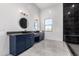 Spacious bathroom featuring dual vanities, sleek fixtures and a window view at 14902 W Oberlin Way, Surprise, AZ 85387