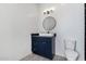 Chic bathroom offering modern lighting, a vessel sink atop a blue vanity, and a nearby toilet at 14902 W Oberlin Way, Surprise, AZ 85387