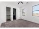 Bedroom with neutral walls, plush carpeting, and view to bathroom and closet at 14902 W Oberlin Way, Surprise, AZ 85387