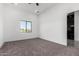 Bright bedroom featuring carpet, window with a view and an open doorway at 14902 W Oberlin Way, Surprise, AZ 85387