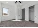 Bright bedroom with carpet, window with a view and an open closet at 14902 W Oberlin Way, Surprise, AZ 85387