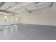 Spacious garage with epoxy floor and ample natural light from multiple windows at 14902 W Oberlin Way, Surprise, AZ 85387
