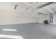 Bright and spacious garage featuring epoxy flooring, sink, and water heater at 14902 W Oberlin Way, Surprise, AZ 85387