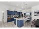 Elegant kitchen with an island, custom blue cabinets, granite countertops, and stainless steel appliances at 14902 W Oberlin Way, Surprise, AZ 85387