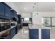 Well-appointed kitchen boasts stainless steel appliances, custom cabinetry, and stylish granite countertops at 14902 W Oberlin Way, Surprise, AZ 85387