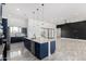 Gourmet kitchen with modern appliances, custom blue cabinetry, and a large island with bar seating at 14902 W Oberlin Way, Surprise, AZ 85387