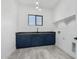 Laundry room features ample counter space, blue cabinets, and modern fixtures for efficient chores at 14902 W Oberlin Way, Surprise, AZ 85387