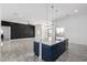 Open living room features modern tile floors, a black accent wall, and sleek contemporary lighting fixtures at 14902 W Oberlin Way, Surprise, AZ 85387