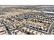 Expansive aerial view of a residential community with many homes, streets, and desert landscape in the background at 1559 E Peregrine Trl, Casa Grande, AZ 85122