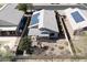 Aerial view of a home with a covered patio, desert landscaping and solar panels at 1559 E Peregrine Trl, Casa Grande, AZ 85122