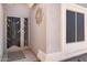 Close up on the front door, featuring security door with decorative sunburst and side window at 1559 E Peregrine Trl, Casa Grande, AZ 85122