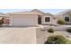 Single story home with desert landscaping, light stucco, tiled roof and two car garage at 1559 E Peregrine Trl, Casa Grande, AZ 85122