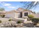 Single story home with desert landscaping, light stucco, tiled roof and two car garage at 1559 E Peregrine Trl, Casa Grande, AZ 85122
