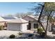 Attractive single-story home with well-kept landscaping and solar panels on the roof at 1559 E Peregrine Trl, Casa Grande, AZ 85122