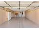 Clean garage with neutral walls and ceiling, storage cabinets, and epoxy floor at 1559 E Peregrine Trl, Casa Grande, AZ 85122