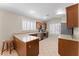 Kitchen featuring stainless steel appliances, wood cabinets, tile flooring, and plantation shutters at 1559 E Peregrine Trl, Casa Grande, AZ 85122