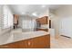Kitchen featuring stainless steel appliances, wood cabinets, tile flooring, and large window at 1559 E Peregrine Trl, Casa Grande, AZ 85122