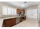 Kitchen featuring stainless steel appliances, wood cabinets, tile flooring, and large window at 1559 E Peregrine Trl, Casa Grande, AZ 85122
