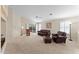 Spacious living room with ceiling fan, sliding glass doors, and comfortable furniture at 1559 E Peregrine Trl, Casa Grande, AZ 85122