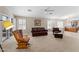 Cozy living room with ceiling fan, sliding glass doors, and an open floor plan at 1559 E Peregrine Trl, Casa Grande, AZ 85122