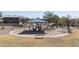 Picture of a park's playground featuring a blue sunshade, several trees, and surrounding residential properties at 1559 E Peregrine Trl, Casa Grande, AZ 85122
