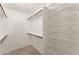 Spacious walk-in closet with carpet, wood rods and white wire shelving at 1559 E Peregrine Trl, Casa Grande, AZ 85122