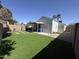 Large backyard featuring artificial grass, a covered patio, and block fencing for added privacy at 17406 N 28Th Dr, Phoenix, AZ 85053