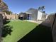 Spacious backyard with artificial grass, a covered patio, and low-maintenance desert landscaping at 17406 N 28Th Dr, Phoenix, AZ 85053